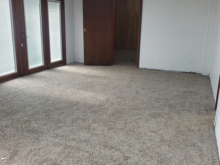 Baseboards being installed new carpet