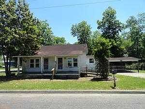 Front of house w/porch and carport
