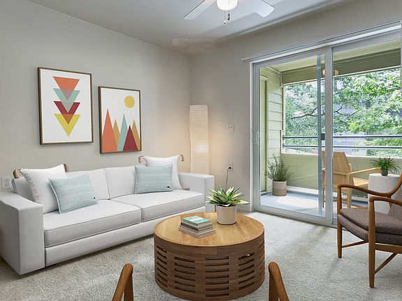 Carpeted Living Room with Balcony