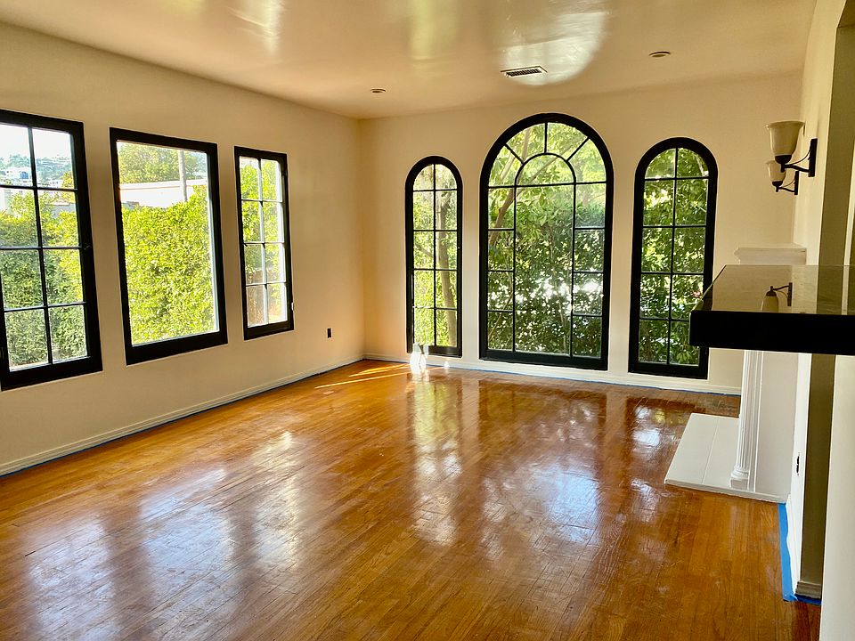 Front room with huge windows overlooking private front yard and loads of light