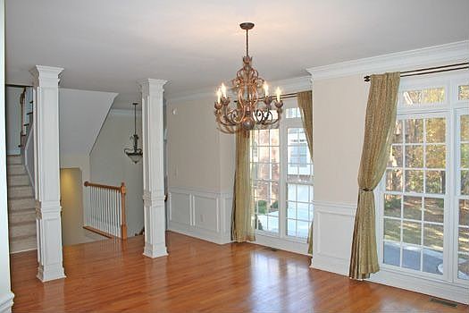 KEEPING ROOM HAS MARBLE FIREPLACE WITH A LARGE TV NOOK.