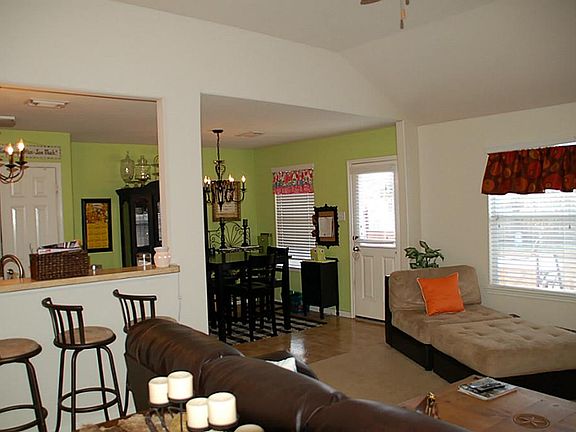 Den is open to kitchen and breakfast room