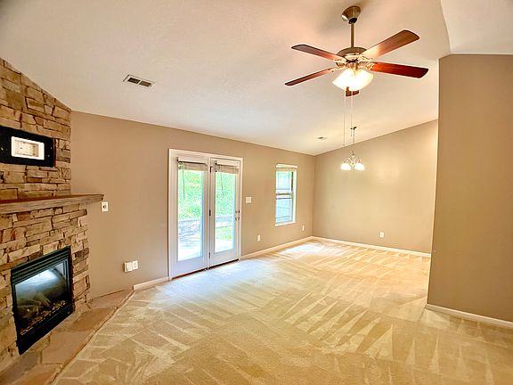 Large open family room with fireplace.