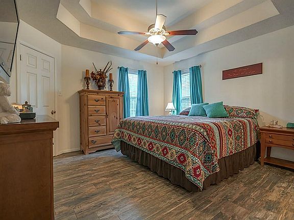 Tray ceiling and natural light add to the beauty of the Master Bedroom new  woodplank  ceramic tile floor treatment