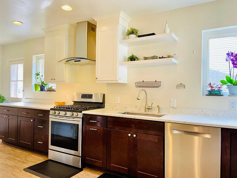 Modern, Sun-filled Kitchen with Stainless Steel Appliance.
