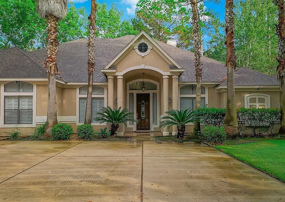 Home features a two car/golf cart garage and attractive landscaping.