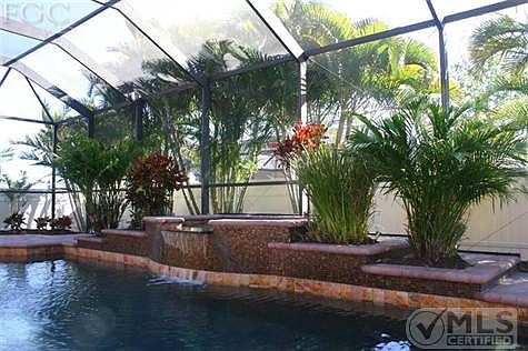 Custom black bottom pool with tile mosiac, waterfall and tropical foilage.  Comes with a pool heater and full summer kitchen, great for entertaining. This outdoor area was built in 2006.