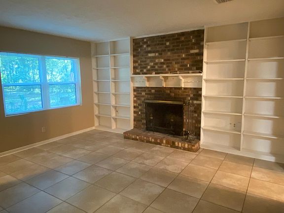 Wood-burning fireplace with custom built-ins. There's also a walk-in closet in the living room.