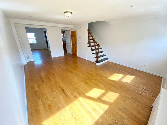 Living room opens to dining room on the left and kitchen to the right