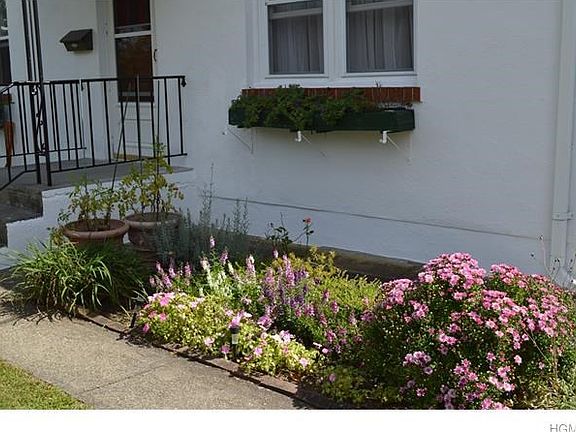 Lovingly landscaped front walk-way and the sweet window box planters give this home nice curb appeal. House is priced to sell, so don't miss out on this one.