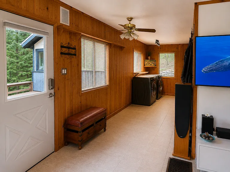 Dedicated mudroom and laundry space with washer and dryer