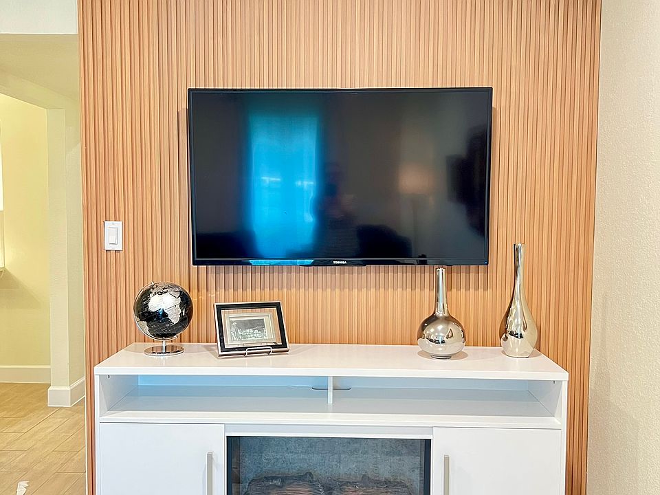 Slat wall with TV and electric fireplace