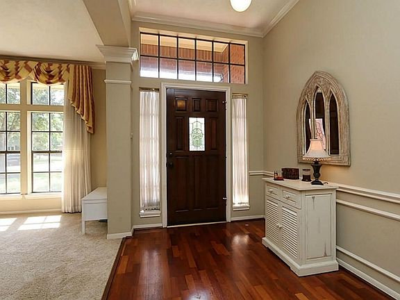 The entry has a beautiful stained front door with side lights and a transom window providing additio