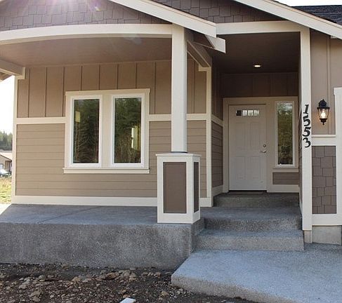 Covered front porch with attractive curved steps.