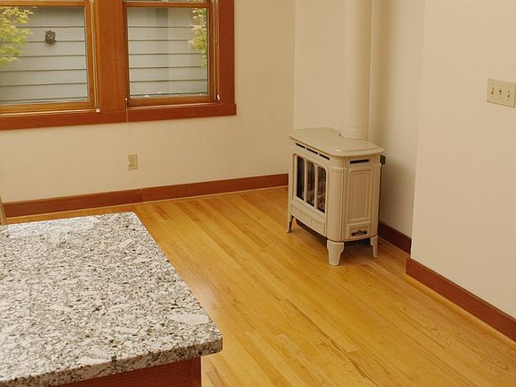 Dining area near south kitchen windows with Hampton heating stove