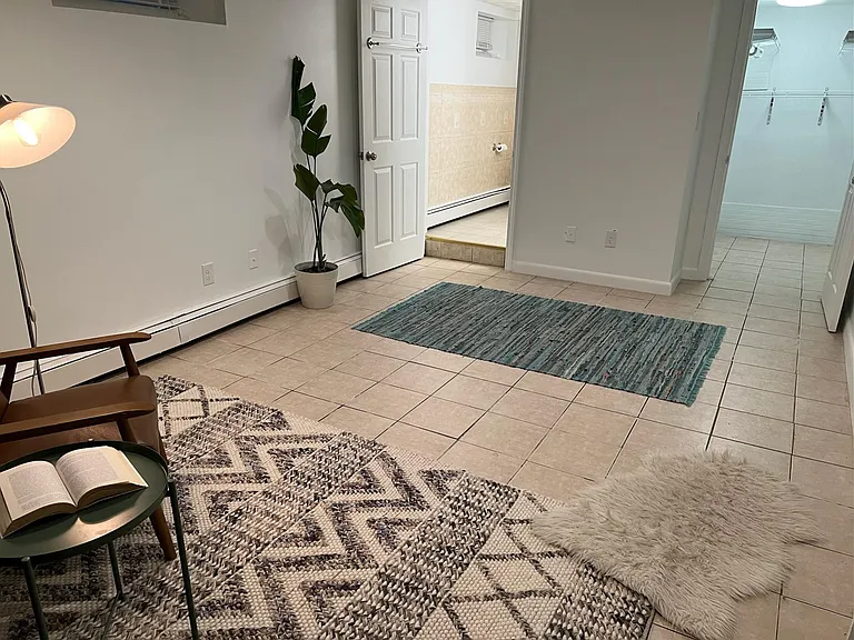 Downstairs bonus room; please note that we have installed new wood flooring throughout this space as well as a door for privacy.