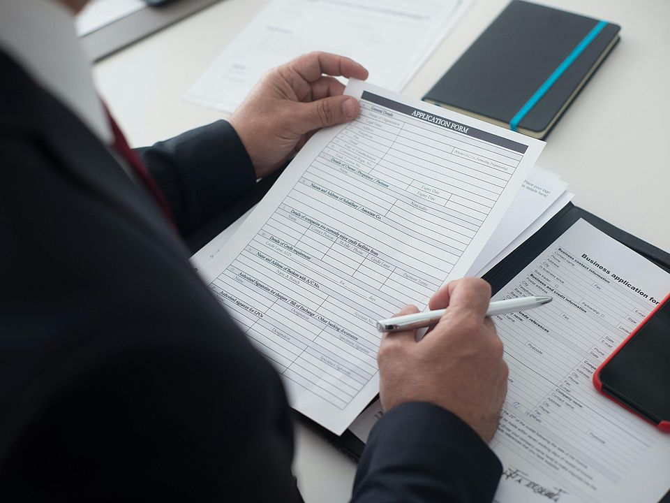 person-holding-a-white-paper-8353794