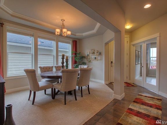 Formal dining room with crown molding in the coffered ceiling. 