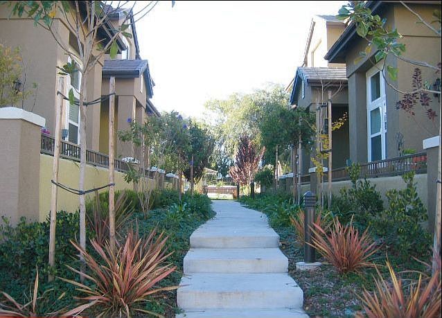 Walkway to front, home is on the right