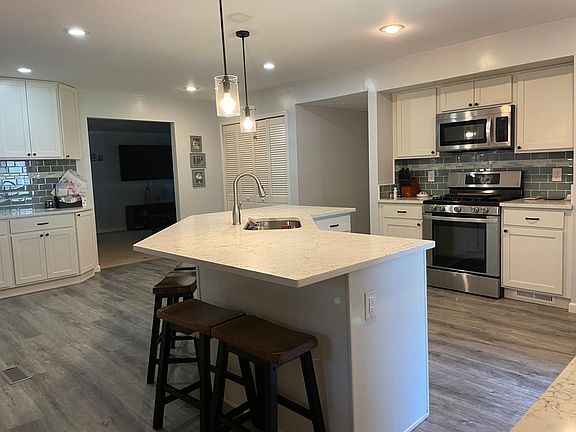 Newly renovated kitchen with stainless steal appliances, quartz countertops, and luxury vinyl plank flooring - durable for kids and pets