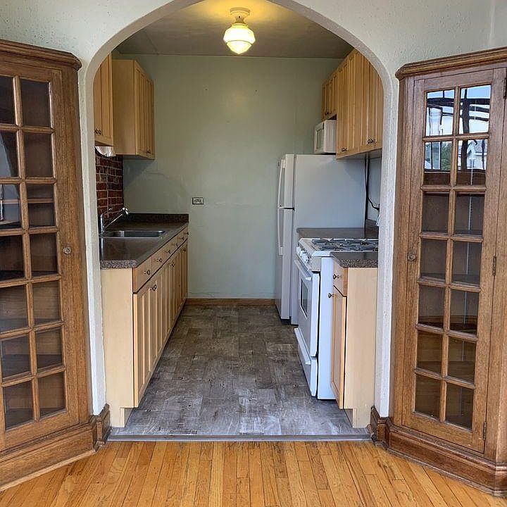 Built in cabinets and arched doorway in dining room.