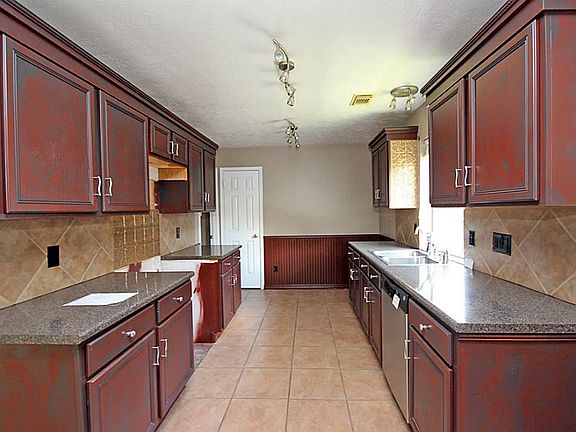 Updated kitchen has pretty tile backsplash that is sure to match any decor!
