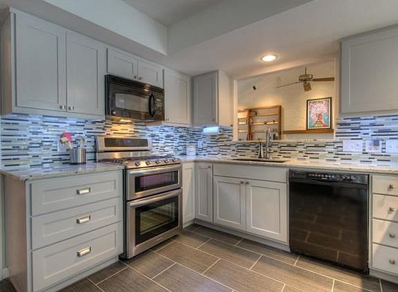 Beautifully updated kitchen, 2 - 100 lb propane tanks specifically installed for range stove top, lower oven is convection oven