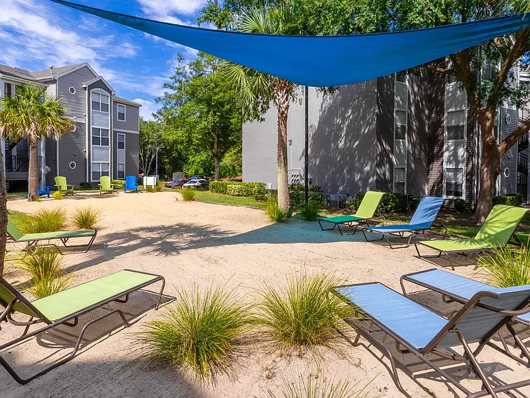 Kick back under the shade and feel the sand between your toes at The Enclave's private beach area.