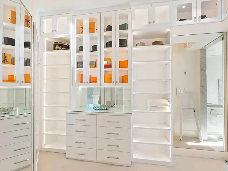 Spacious walk-in closet with full length mirrors.