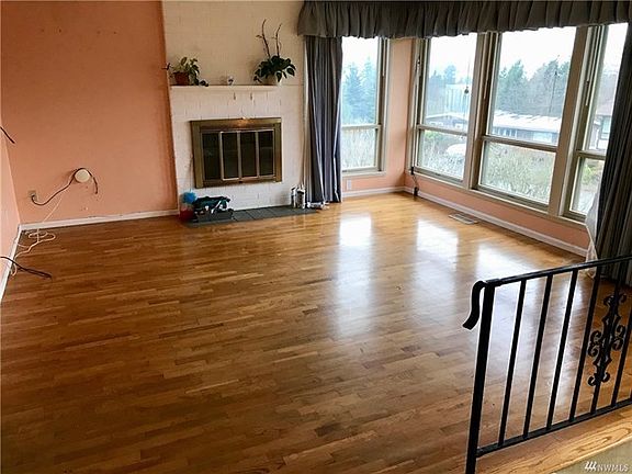 Living room has a wood fireplace and the large windows let in such an expanse of light even on cloudy days. Enjoy the view of the sound from your couch while enjoying the crackle of the fireplace.?