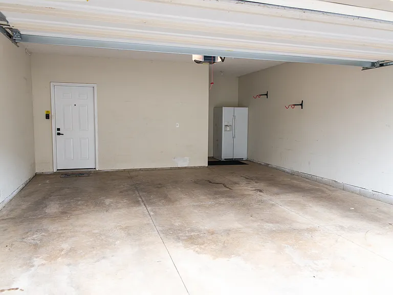 Huge two-car garage with bonus fridge (included), and nook for extra storage space