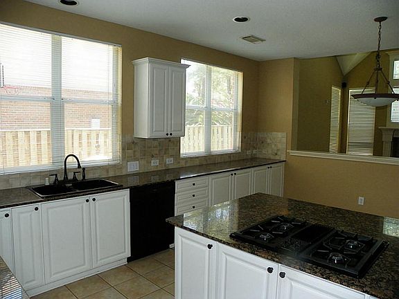 Enjoy your tiled kitchen with island cooktop.