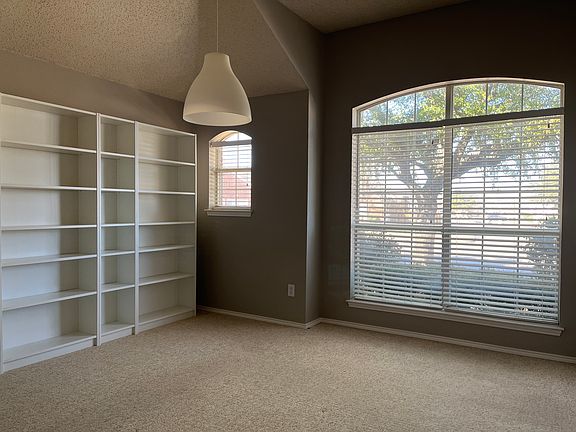Large front flex room with wall of bookcases.