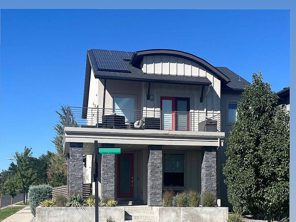 Front of home on great corner with mountain views from top balcony. Also notice the solar panels!