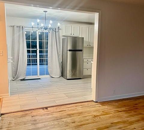 Living room looking into newly remodeled kitchen. Pictures were taken at night. There is a lot of natural light during the day.