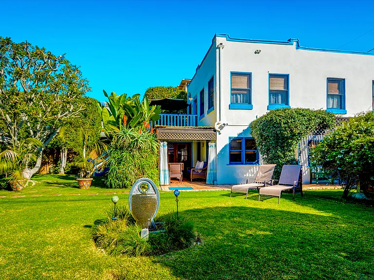 Large Gated Yard ~ fountain (foreground), lounge chairs (right), cabana (center)