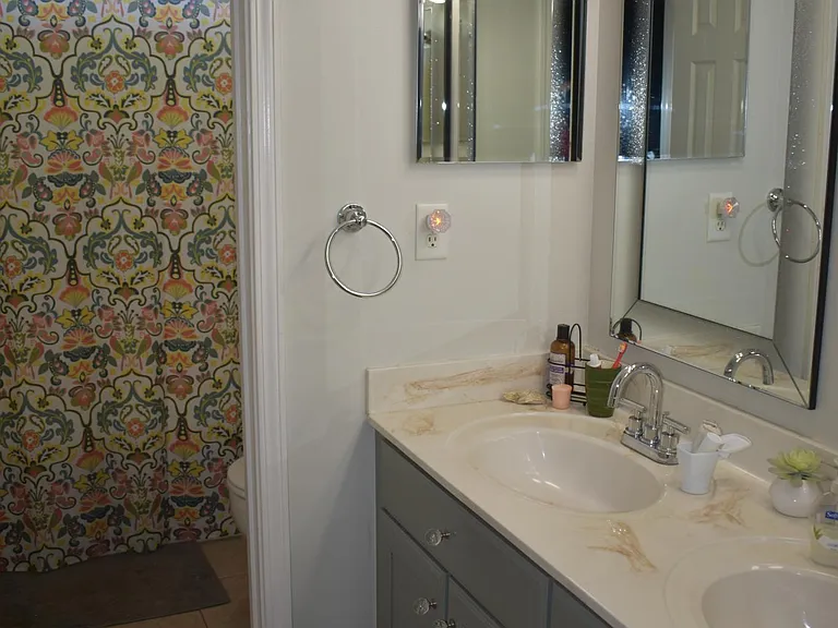 One of two upstairs bathrooms--double vanity and shower-tub combo