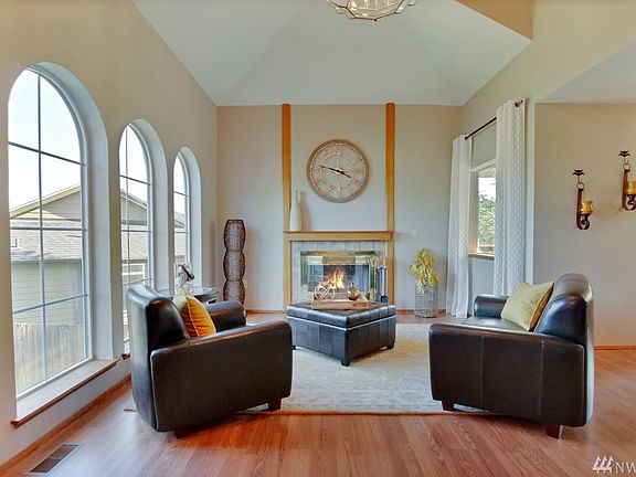 Enjoy the Formal Living Room w/ Cathedral Ceilings, Hardwood Floors, Arched Windows & Wood Burning Fireplace. Lots of Windows for Natural Lighting.