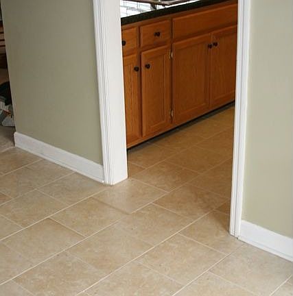 Garage door opens into newly tiled entry hall and kitchen