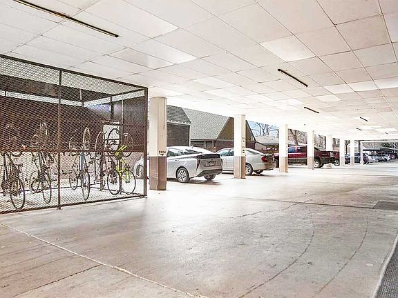 Controlled access bike cage and parking area by south door, South Building. Parking for 1006S is the second parking space.