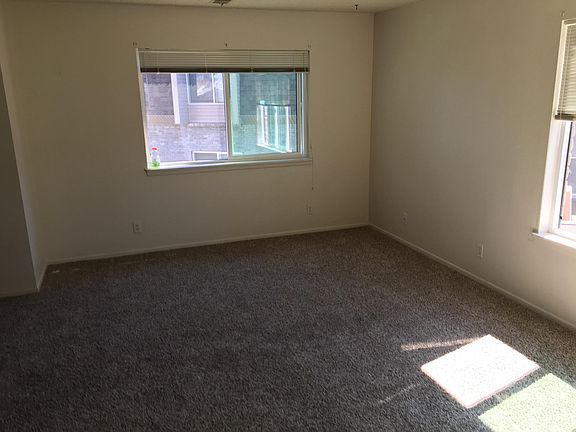 Spacious living room with plenty of warm natural light.