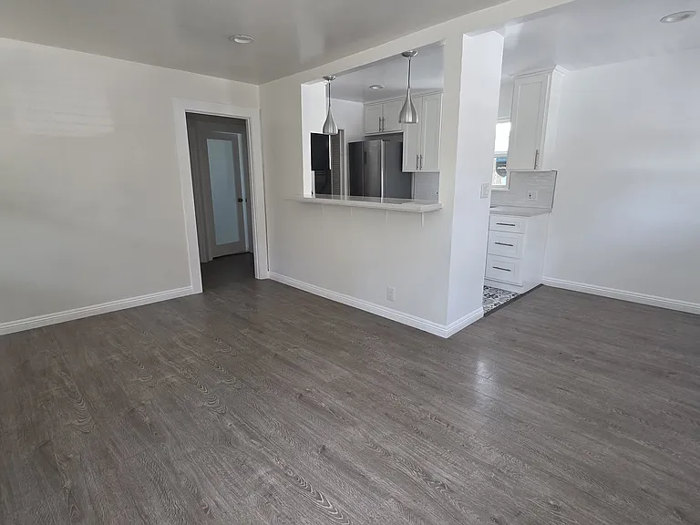 Large living and dining area with kitchen counter. Lots of natural light!