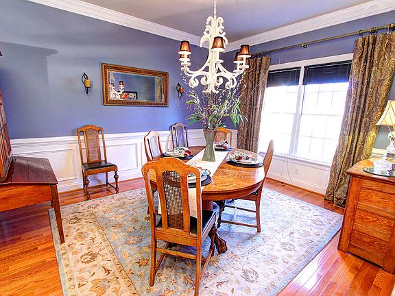 Formal Dining Room with Heavy Moldings, Custom Chandelier, Wood Floors