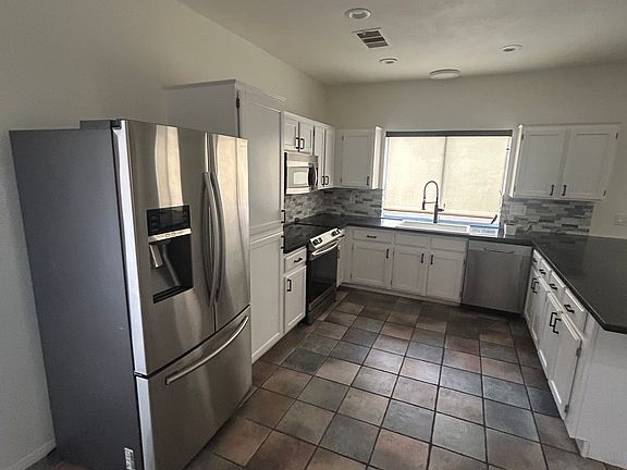 Updated kitchen with stainless appliances, cabinets and countertops