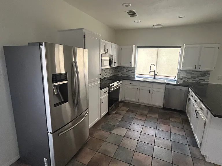 Updated kitchen with stainless appliances, cabinets and countertops