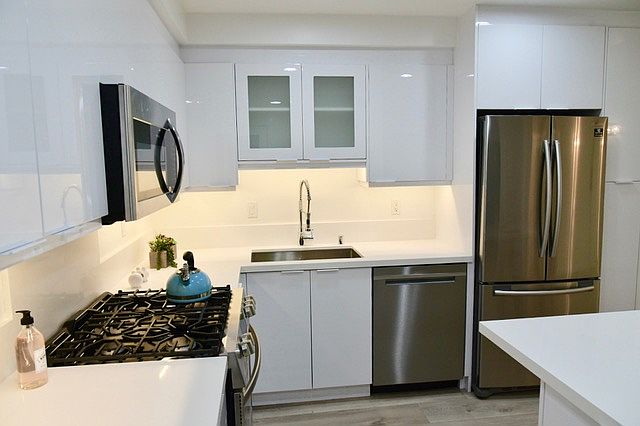 Large kitchen with stainless steel appliances and gas oven/stove