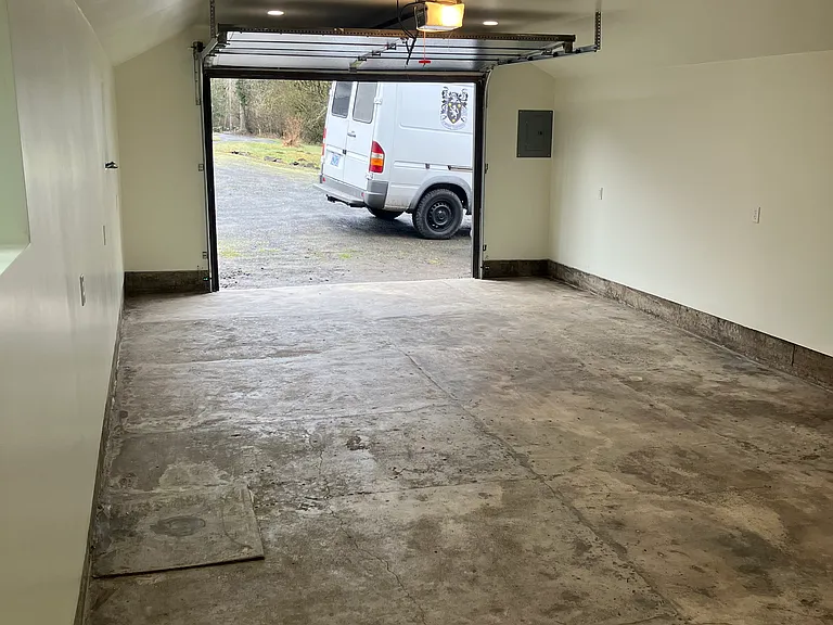 400sqft detached garage is insulated with finished drywall walls and concrete floor.