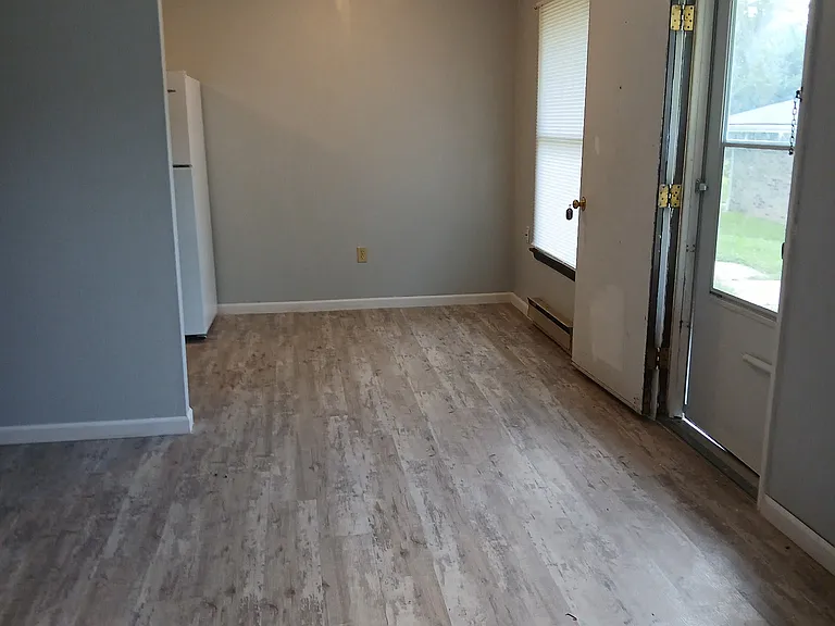 Living room looking at dining area and entry.