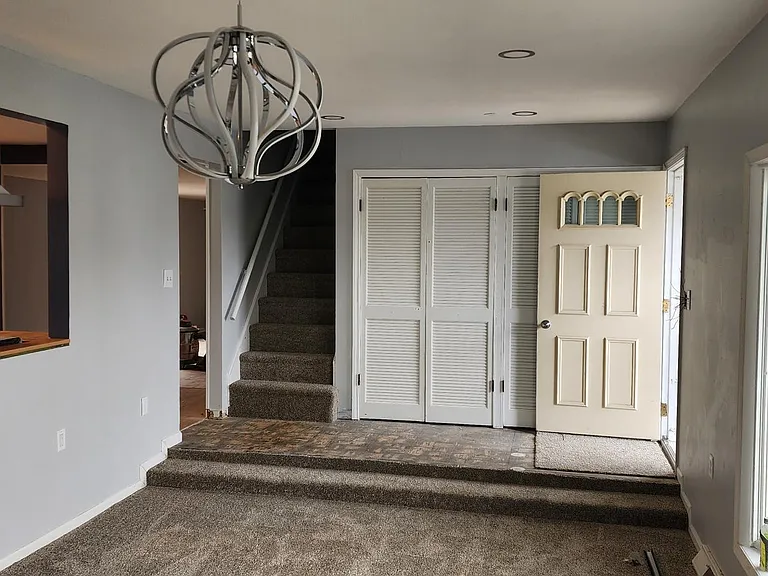 I like the lamp in the living room. Kitchen to your left. Entrance to upstairs. 8x8 large closet. Main entrance. Check out the tons of natural light.