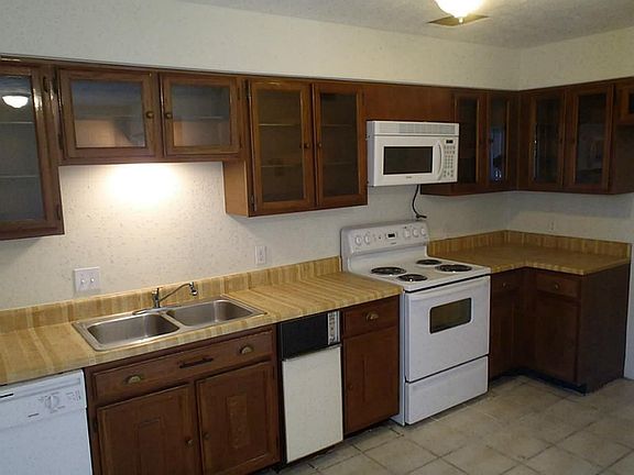 View of kitchen shows updated appliances